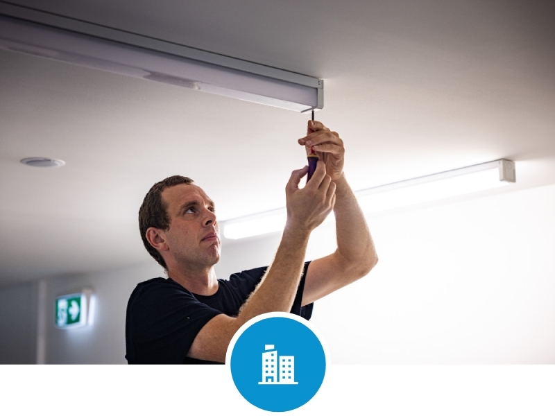 Applied Electrical electrician replacing light in commercial office space
