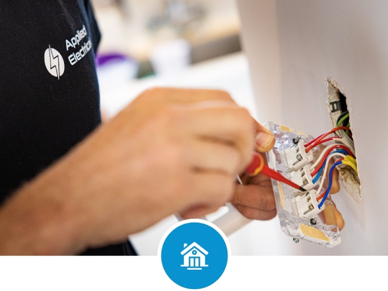 Applied Electrical electrician installing a light switch in a residential home