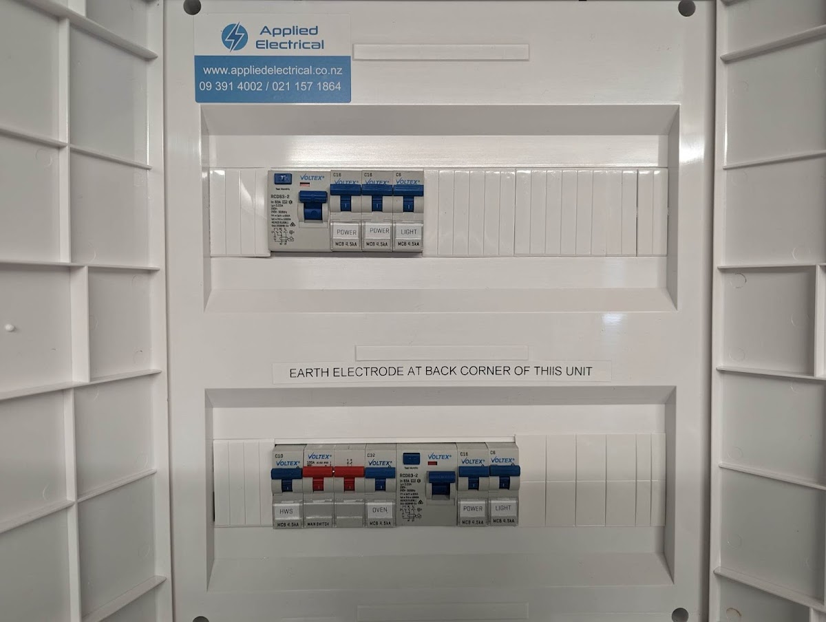 Modern switchboard installed by Applied Electrical with branded sticker