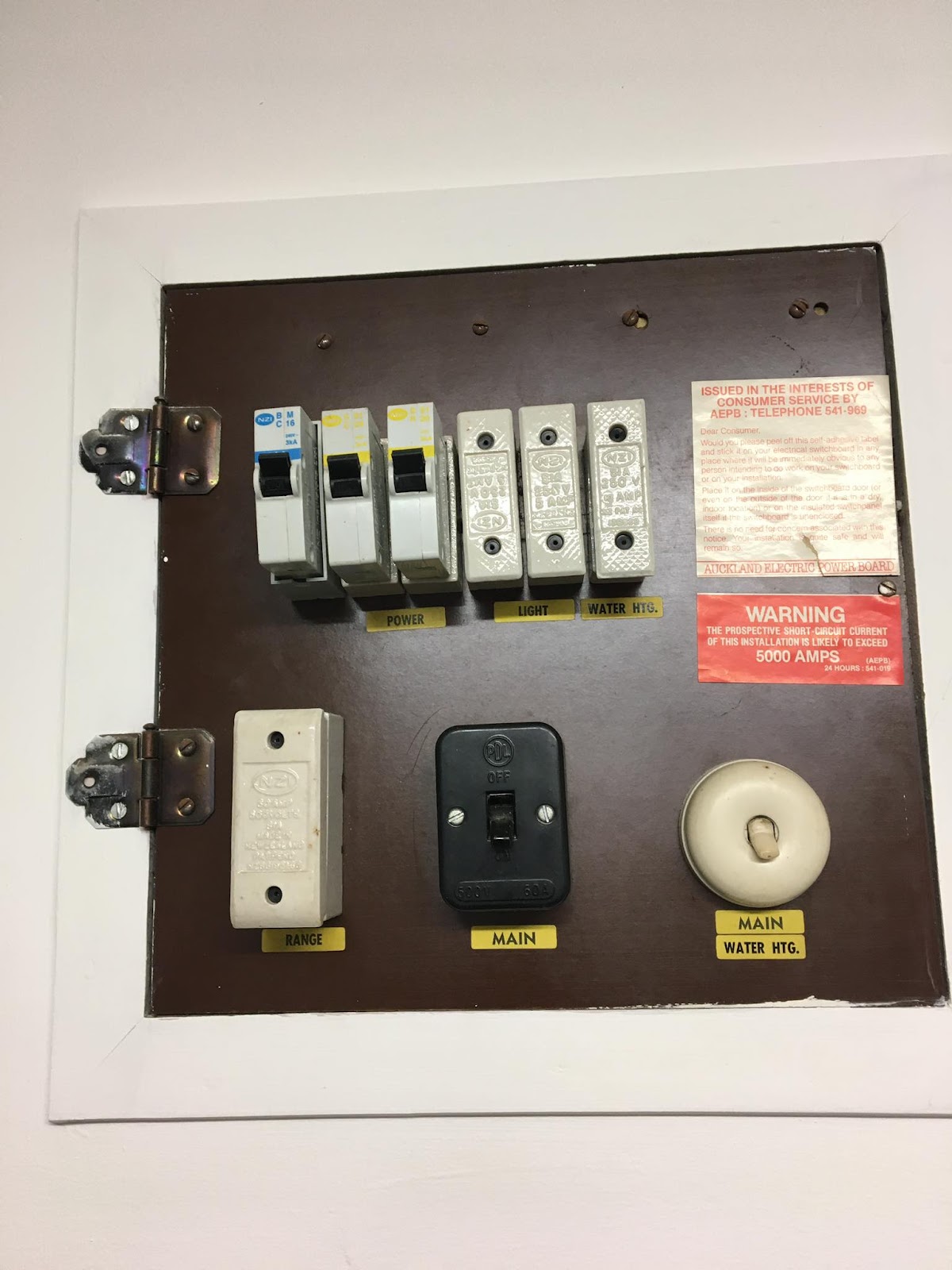 Old switchboard with ceramic fuses and bakelite panel — before upgrade